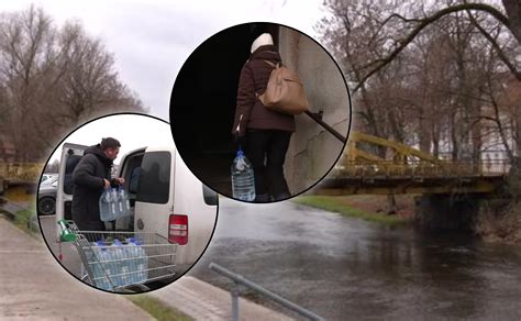 Žmonės, gerianti vandenį iš šulinio